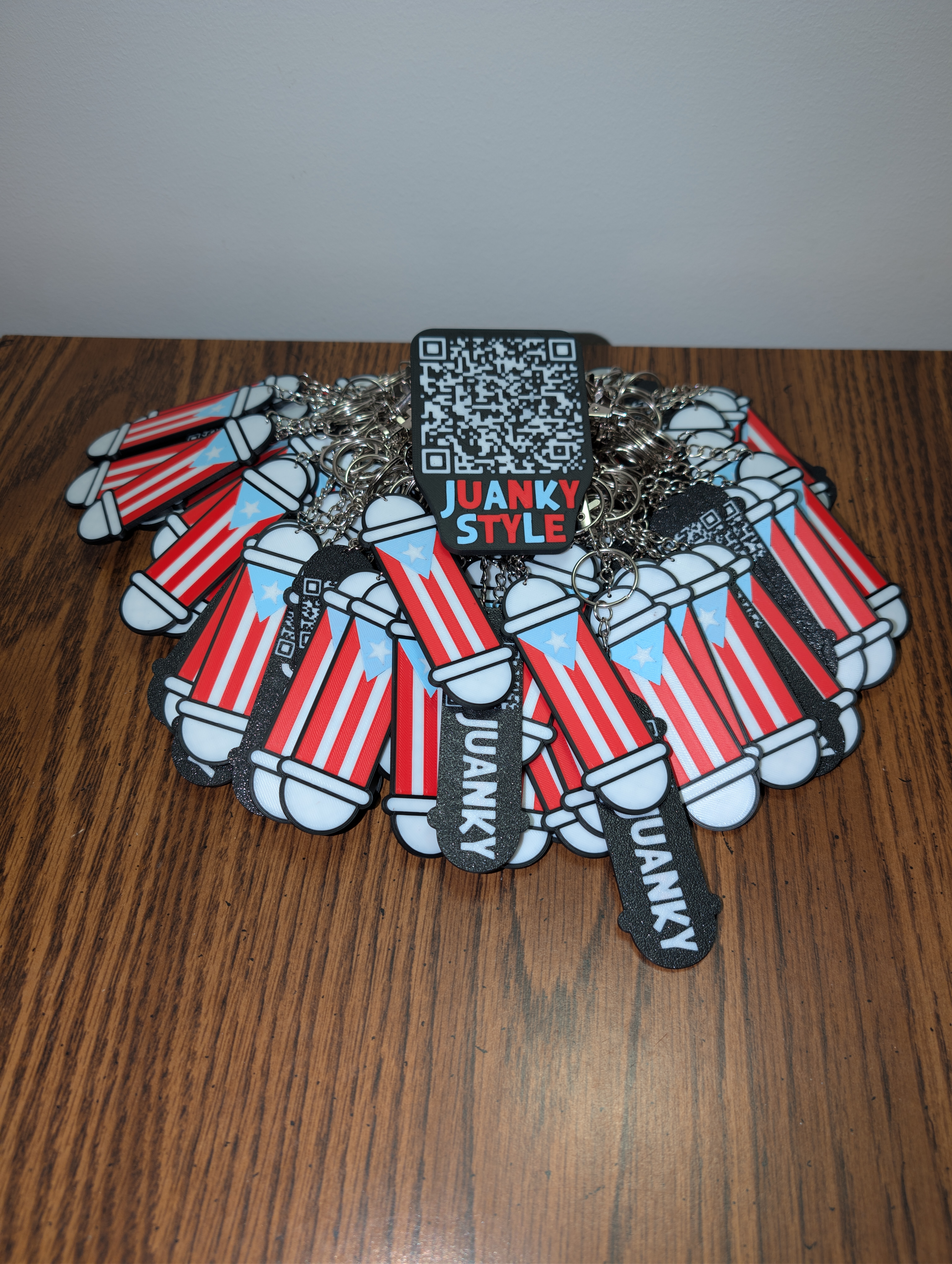 Pile of Juanky Style keychains with QR card